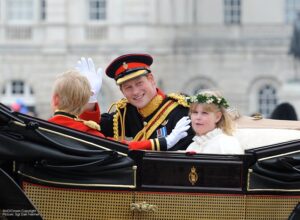 Principe Harry che saluta dalla carrozza