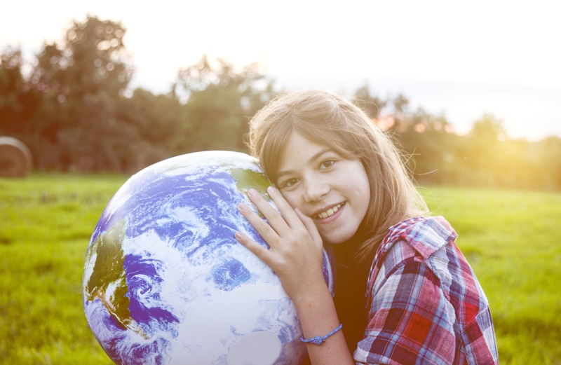 Girl embracing globe
