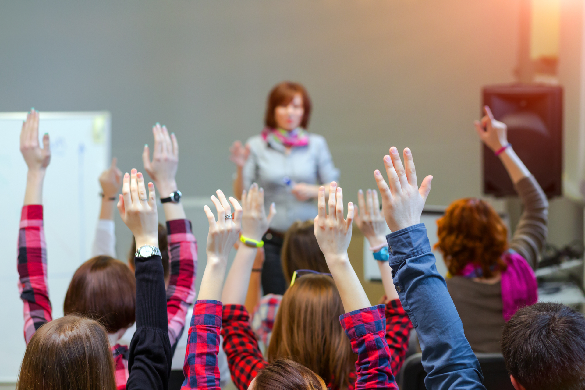 Improvisation for the language classroom. It works. Active Students raising Arms up ready to answer Teachers Question
