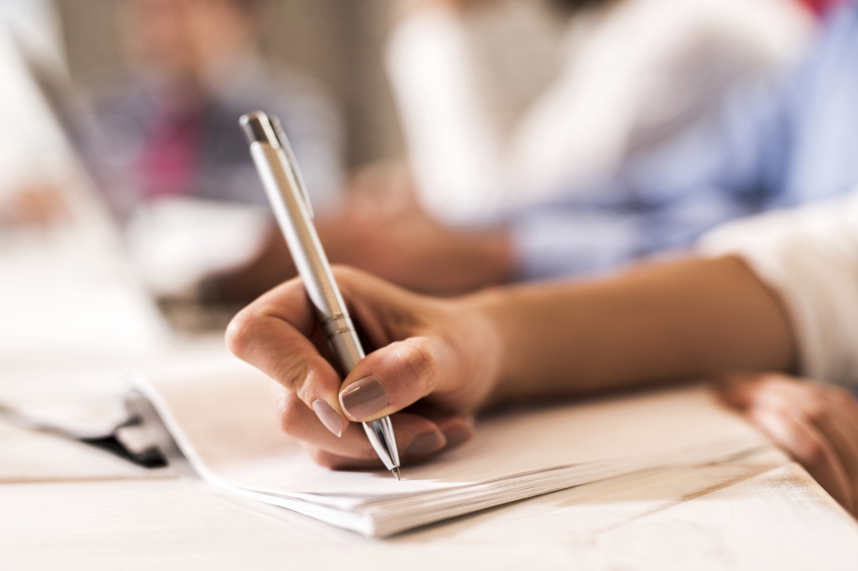 Helping Higher Level Learners with Planning, Drafting and Editing when Writing Unrecognizable person writing on a piece of paper.