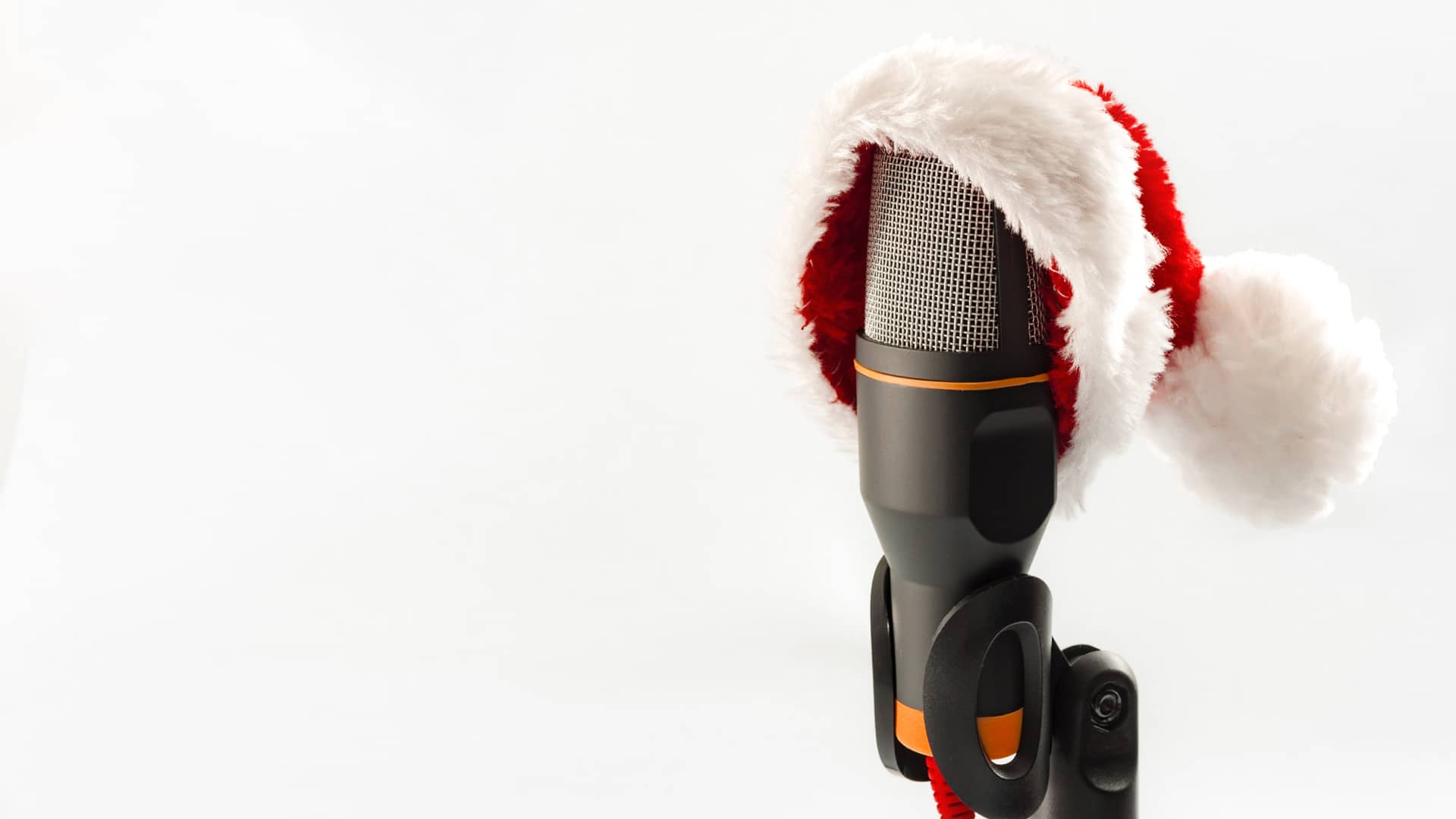 I Carols e Charles Dickens: una lezione di inglese Microphone wearing santa hat on white background with copyspace
